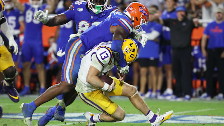 Nov 16, 2024; Gainesville, Florida, USA; Florida Gators linebacker Shemar James (6) and defensive lineman Caleb Banks (88) sack LSU Tigers quarterback Garrett Nussmeier (13) during the second half at Ben Hill Griffin Stadium. Mandatory Credit: Kim Klement Neitzel-Imagn Images