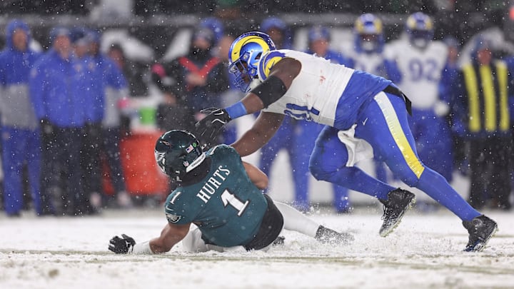 Jan 19, 2025; Philadelphia, Pennsylvania, USA; Philadelphia Eagles quarterback Jalen Hurts (1) is sacked by Los Angeles Rams defensive tackle Kobie Turner (91) in the second half in a 2025 NFC divisional round game at Lincoln Financial Field. Mandatory Credit: Bill Streicher-Imagn Images