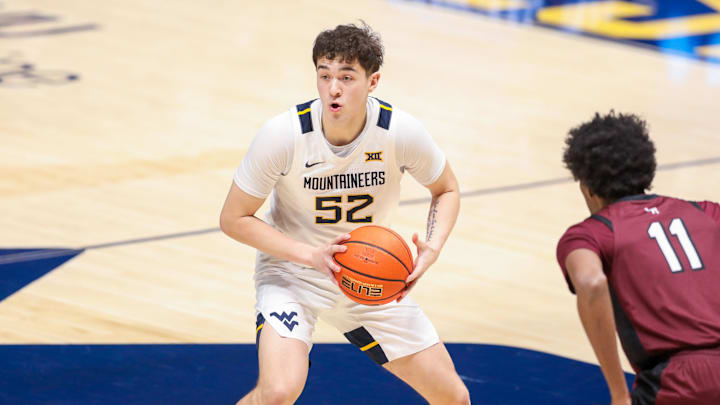 Dec 9, 2025; Morgantown, West Virginia, USA; West Virginia Mountaineers guard Treysen Eaglestaff (52) passes the ball during the first half against the Little Rock Trojans at Hope Coliseum. Mandatory Credit: Ben Queen-Imagn Images