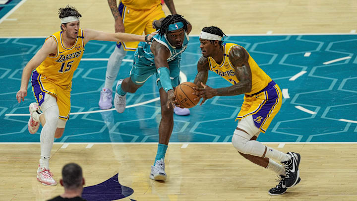 Jan 27, 2025; Charlotte, North Carolina, USA; Charlotte Hornets center Mark Williams (5) tries for a steal from Los Angeles Lakers forward Jarred Vanderbilt (2) during the second half at the Spectrum Center. Mandatory Credit: Jim Dedmon-Imagn Images