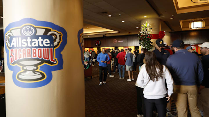 Fans line at the front desk of the Sheraton hotel after the Sugar Bowl CFP quarterfinal between Georgia and Notre Dame was postponed after an attack on Bourbon Street.