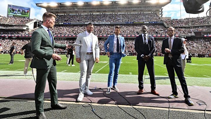 Sep 23, 2023; College Station, Texas, USA; SEC Nation crew speak on the sideline during pre-game between the Texas A&M Aggies and the Auburn Tigers; Marty Smith (far left, Tim Tebow (center left), Jordan Rodgers (center), Roman Harper (center right), Paul Finebaum (far right) at Kyle Field. Mandatory Credit: Maria Lysaker-Imagn Images