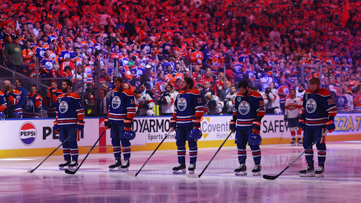 Edmonton Oilers players line up for the national anthems