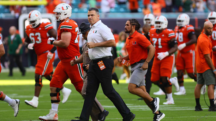 Sep 7, 2024; Miami Gardens, Florida, USA; Miami Hurricanes head coach Mario Cristobal runs on the field before the game against the Florida A&M Rattlers at Hard Rock Stadium. Mandatory Credit: Sam Navarro-Imagn Images