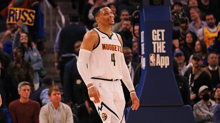 Mar 17, 2025; San Francisco, California, USA; Denver Nuggets guard Russell Westbrook (4) smiles ahead of a sign reading “Russ” after a play against the Golden State Warriors during the fourth quarter at Chase Center. Mandatory Credit: Kelley L Cox-Imagn Images Mar 17, 2025; San Francisco, California, USA; Denver Nuggets guard Russell Westbrook (4) smiles ahead of a sign reading “Russ” after a play against the Golden State Warriors during the fourth quarter at Chase Center. Mandatory Credit: Kelley L Cox-Imagn Images