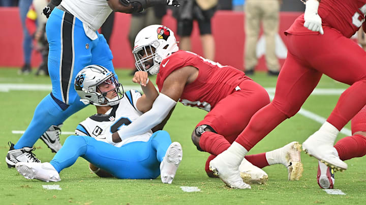 Sep 14, 2025; Glendale, Arizona, USA;  Arizona Cardinals linebacker Josh Sweat (10) tackles Carolina Panthers quarterback Bryce Young (9) during the first quarter at State Farm Stadium. Mandatory Credit: Matt Kartozian-Imagn Images