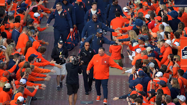 Oct 11, 2025; Champaign, Illinois, USA;  Illinois Fighting Illini head coach Bret Bielema leads his team in the Illini Walk before an NCAA game against the Ohio State Buckeyes at Memorial Stadium. Mandatory Credit: Ron Johnson-Imagn Images