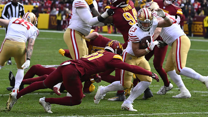 Dec 31, 2023; Landover, Maryland, USA; San Francisco 49ers running back Christian McCaffrey (23) is tackled by Washington Commanders safety Kamren Curl (31) during the first half at FedExField. Mandatory Credit: Brad Mills-Imagn Images Dec 31, 2023; Landover, Maryland, USA; San Francisco 49ers running back Christian McCaffrey (23) is tackled by Washington Commanders safety Kamren Curl (31) during the first half at FedExField. Mandatory Credit: Brad Mills-Imagn Images