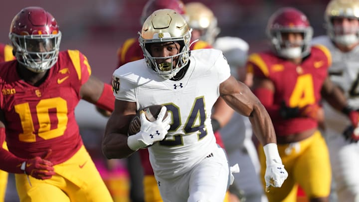 Nov 30, 2024; Los Angeles, California, USA; Notre Dame Fighting Irish running back Jadarian Price (24) scores on a 36-yard touchdown run against the Southern California Trojans in the second half at United Airlines Field at Los Angeles Memorial Coliseum. Mandatory Credit: Kirby Lee-Imagn Images