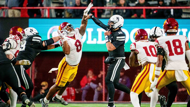 Nov 1, 2025; Lincoln, Nebraska, USA; Nebraska Cornhuskers quarterback Dylan Raiola (15) passes against Southern California Trojans defensive tackle Devan Thompkins (8) during the second quarter at Memorial Stadium. Mandatory Credit: Dylan Widger-Imagn Images