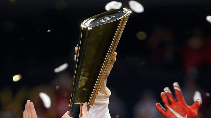 Ohio State Buckeyes head coach Urban Meyer holds up the National Championship trophy after beating Oregon Ducks 42-20 in College Football Playoff Championship game at AT&T Stadium in Arlington, Texas on January 12, 2015. (Dispatch photo by Kyle Robertson)
