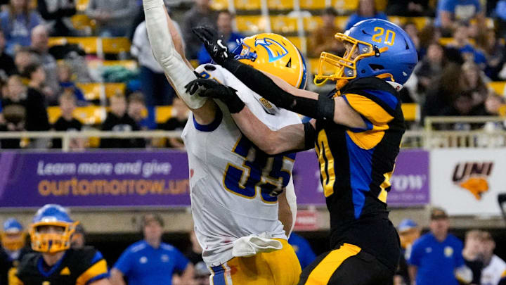Wahlert Catholic's Tate Schope (35) and Humboldt's Chase Flaherty (20) reach for a pass during the Iowa high school Class 3A championship Friday, Nov. 22, 2024 at the UNI-Dome in Cedar Falls, Iowa.