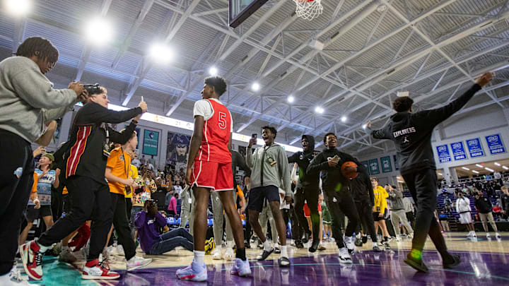 Jaxon Richardson stands as people around celebrate his dunk during the 50th annual City of Palms Classic dunk contest at Suncoast 