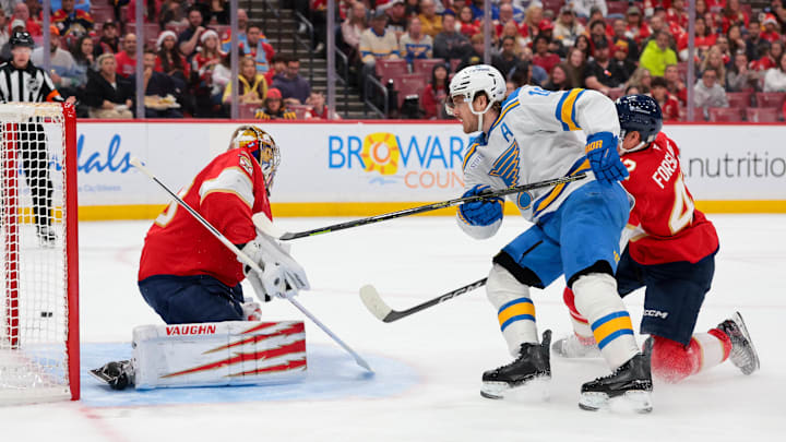 Dec 20, 2025; Sunrise, Florida, USA; St. Louis Blues center Robert Thomas (18) shoots the puck as Florida Panthers goaltender Daniil Tarasov (40) defends his net during the first period at Amerant Bank Arena. Mandatory Credit: Sam Navarro-Imagn Images