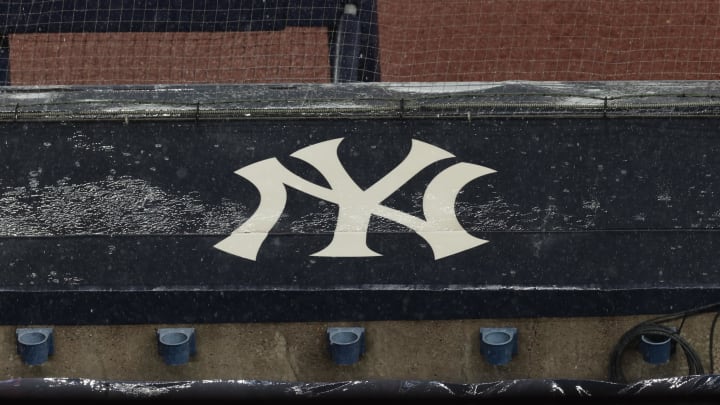 Aug 17, 2020; Bronx, New York, USA; A general view of rain falling on the  New York Yankees logo on the first base dugout roof during a rain delay in the game between the New York Yankees and the Boston Red Sox. Mandatory Credit: Vincent Carchietta-USA TODAY Sports