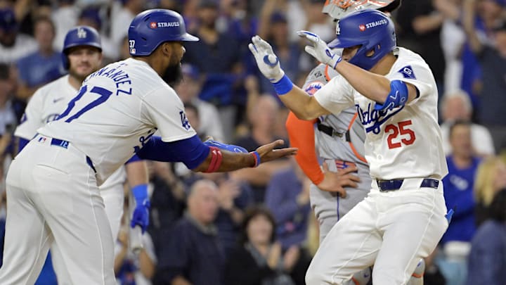 Oct 20, 2024; Los Angeles, California, USA; Los Angeles Dodgers shortstop Tommy Edman (25) celebrates with outfielder Teoscar Hernandez (37) after scoring on a two run home run in the third inning against the New York Mets during game six of the NLCS for the 2024 MLB playoffs at Dodger Stadium. Mandatory Credit: Jayne Kamin-Oncea-Imagn Images