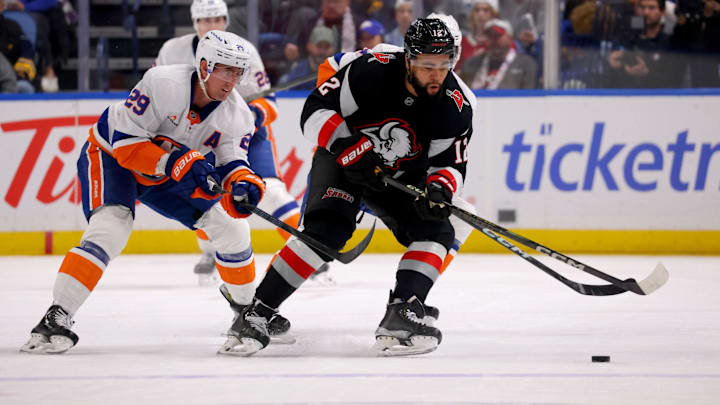 Nov 1, 2024; Buffalo, New York, USA;  New York Islanders center Brock Nelson (29) and Buffalo Sabres left wing Jordan Greenway (12) go after a loose puck during the first period at KeyBank Center. Mandatory Credit: Timothy T. Ludwig-Imagn Images