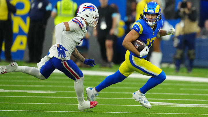 Dec 8, 2024; Inglewood, California, USA; Los Angeles Rams wide receiver Puka Nacua (17) carries the ball against Buffalo Bills cornerback Taron Johnson (7) in the second half at SoFi Stadium. Mandatory Credit: Kirby Lee-Imagn Images