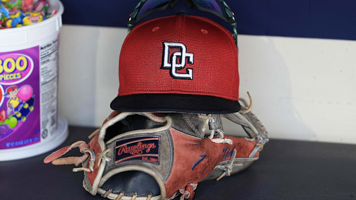 Jul 12, 2024; Milwaukee, Wisconsin, USA;  An Washington Nationals hat and glove sit in the dugout during batting practice prior to the game against the Milwaukee Brewers at American Family Field. 