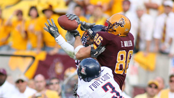 Nov 25, 2005; Tempe, AZ, USA; Arizona Wildcats defenders Wilrey Fontenot (#3) and Quenton Freeman (#26) battle for the ball against Arizona State Sun Devils tight end Zach Miller (#86) at Sun Devil Stadium, the pass was incomplete, Mandatory Credit: Rick Scuteri-Imagn Images Copyright Rick Scuteri