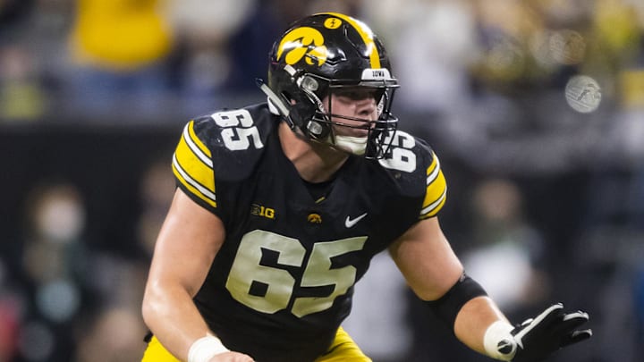 Dec 4, 2021; Indianapolis, IN, USA; Iowa Hawkeyes center Tyler Linderbaum (65) against the Michigan Wolverines in the Big Ten Conference championship game at Lucas Oil Stadium. Mandatory Credit: Mark J. Rebilas-Imagn Images
