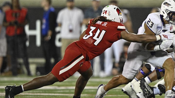 Sep 5, 2025; Louisville, Kentucky, USA; James Madison Dukes running back Jordan Fuller (23) runs the ball against Louisville Cardinals linebacker TJ Quinn (34) during the second half at L&N Federal Credit Union Stadium. Mandatory Credit: Jamie Rhodes-Imagn Images Sep 5, 2025; Louisville, Kentucky, USA; James Madison Dukes running back Jordan Fuller (23) runs the ball against Louisville Cardinals linebacker TJ Quinn (34) during the second half at L&N Federal Credit Union Stadium. Mandatory Credit: Jamie Rhodes-Imagn Images
