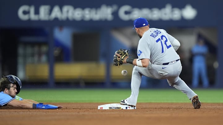Oct 31, 2025; Toronto, Ontario, CAN; Los Angeles Dodgers second baseman Miguel Rojas (72) makes a double play against Toronto Blue Jays third baseman Addison Barger (47) in the ninth inning during game six of the 2025 MLB World Series at Rogers Centre. Mandatory Credit: John E. Sokolowski-Imagn Images Oct 31, 2025; Toronto, Ontario, CAN; Los Angeles Dodgers second baseman Miguel Rojas (72) makes a double play against Toronto Blue Jays third baseman Addison Barger (47) in the ninth inning during game six of the 2025 MLB World Series at Rogers Centre. Mandatory Credit: John E. Sokolowski-Imagn Images