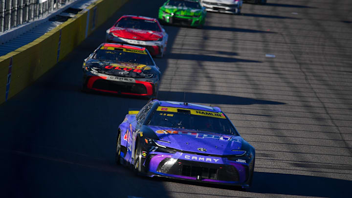 Oct 12, 2025; Las Vegas, Nevada, USA; NASCAR Cup Series driver Denny Hamlin (11) leads driver Chase Briscoe (19) during the South Point 400 at Las Vegas Motor Speedway.