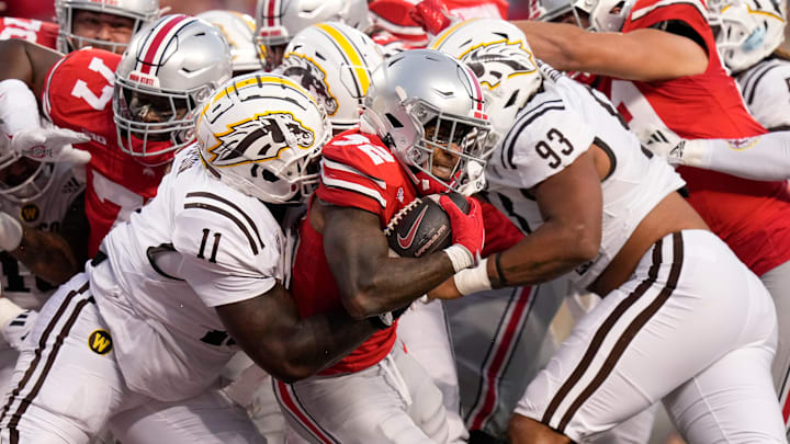 Sep 7, 2024; Columbus, Ohio, USA; Ohio State Buckeyes running back TreVeyon Henderson (32) muscles his way into the endzone for a touchdown past Western Michigan Broncos defensive lineman Anterio Thompson (11) and defensive lineman Corey Walker (93) during the first half of the NCAA football game at Ohio Stadium. Sep 7, 2024; Columbus, Ohio, USA; Ohio State Buckeyes running back TreVeyon Henderson (32) muscles his way into the endzone for a touchdown past Western Michigan Broncos defensive lineman Anterio Thompson (11) and defensive lineman Corey Walker (93) during the first half of the NCAA football game at Ohio Stadium.