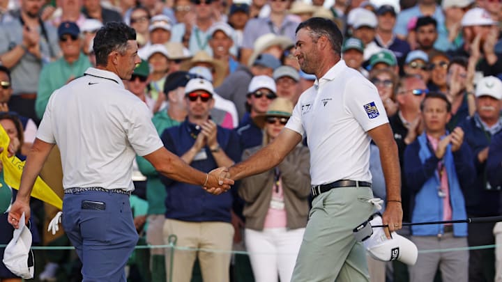 Corey Conners (right) withstood a fearsome round by Rory McIlroy (left) to position himself for a run at the green jacket Sunday. 