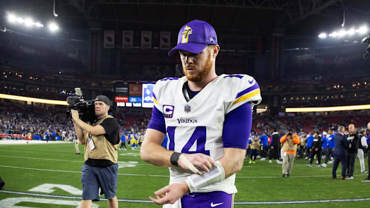 Jan 13, 2025; Glendale, AZ, USA; Minnesota Vikings quarterback Sam Darnold (14) reacts as he walks off the field after losing to the Los Angeles Rams during an NFC wild card game at State Farm Stadium. Mandatory Credit: Mark J. Rebilas-Imagn Images