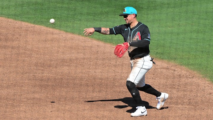 Feb 25, 2026; Salt River Pima-Maricopa, Arizona, USA; Arizona Diamondbacks second baseman Ildemaro Vargas (6) throws to first base the third inning against the Los Angeles Dodgers at Salt River Fields at Talking Stick. Mandatory Credit: Matt Kartozian-Imagn Images