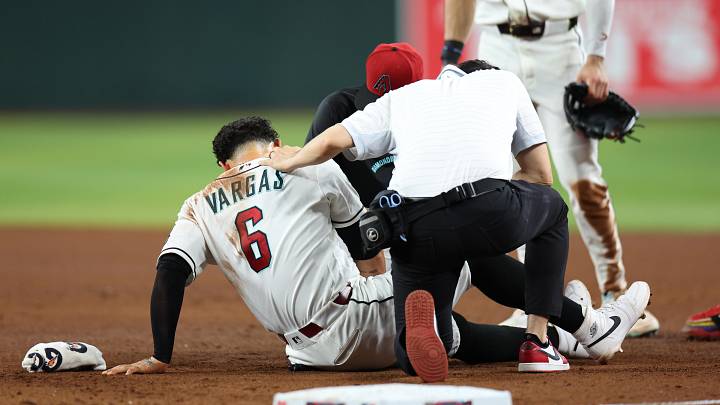 Jun 4, 2026; Phoenix, Arizona, USA; Arizona Diamondbacks athletic trainers tend to first baseman Ildemaro Vargas (6) after a collision with Los Angeles Dodgers third baseman Max Muncy (not pictured) during the fifth inning at Chase Field. Mandatory Credit: Anna Carrington-Imagn Images