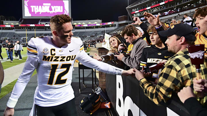 Nov 23, 2024; Starkville, Mississippi, USA; Missouri Tigers quarterback Brady Cook (12) reacts with fans after a game against the Mississippi State Bulldogs at Davis Wade Stadium at Scott Field. Mandatory Credit: Matt Bush-Imagn Images Nov 23, 2024; Starkville, Mississippi, USA; Missouri Tigers quarterback Brady Cook (12) reacts with fans after a game against the Mississippi State Bulldogs at Davis Wade Stadium at Scott Field. Mandatory Credit: Matt Bush-Imagn Images