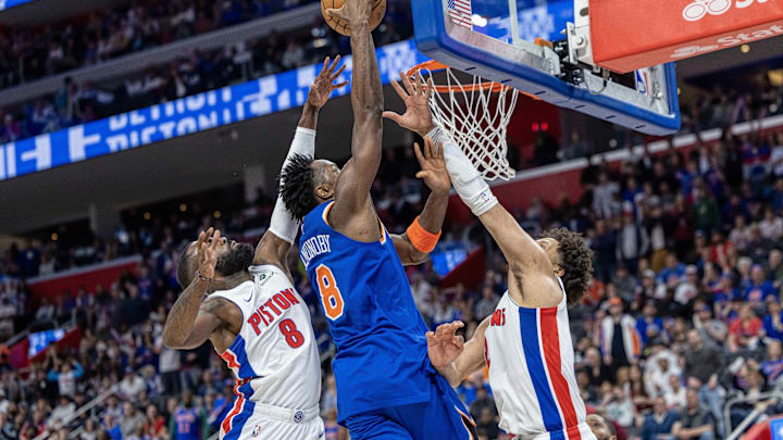 Apr 27, 2025; Detroit, Michigan, USA; New York Knicks forward OG Anunoby (8) drives to the basket between Detroit Pistons guard Cade Cunningham (2) and forward Tim Hardaway Jr. (8) during the second quarter of game four of first round for the 2025 NBA Playoffs at Little Caesars Arena. Mandatory Credit: David Reginek-Imagn Images