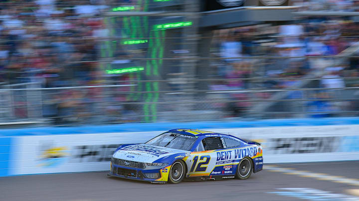 Mar 8, 2026; Avondale, Arizona, USA; Team Penske driver Ryan Blaney (12) crosses the line to win the Straight Talk Wireless 500 at Phoenix Raceway.