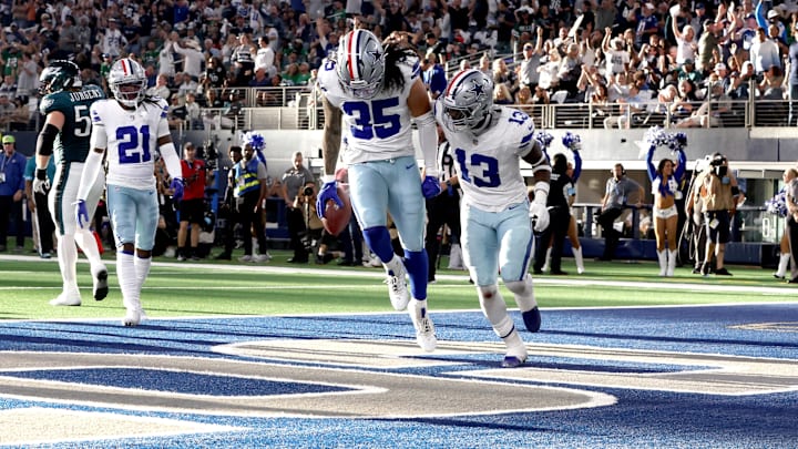 Dallas Cowboys linebackers Marist Liufau and DeMarvion Overshown react to recovering a fumble.