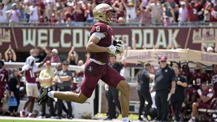 Sep 6, 2025; Tallahassee, Florida, USA; Florida State Seminoles wide receiver Duce Robinson (0) catches a touchdown during the first half against the East Texas A&M at Doak S. Campbell Stadium. Mandatory Credit: Melina Myers-Imagn Images