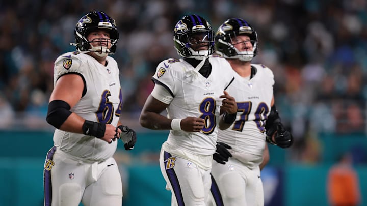 Oct 30, 2025; Miami Gardens, Florida, USA; Baltimore Ravens quarterback Lamar Jackson (8) runs up to the line with center Tyler Linderbaum (64) and offensive tackle Roger Rosengarten (70) during the third quarter against the Miami Dolphins at Hard Rock Stadium. Mandatory Credit: Sam Navarro-Imagn Images