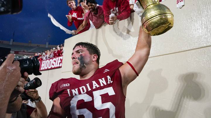 Oct 18, 2025; Bloomington, Indiana, USA; Indiana Hoosiers offensive lineman Carter Smith (65) celebrates with the Old Brass Spittoon after the game against the Michigan State Spartans at Memorial Stadium. Mandatory Credit: Robert Goddin-Imagn Images