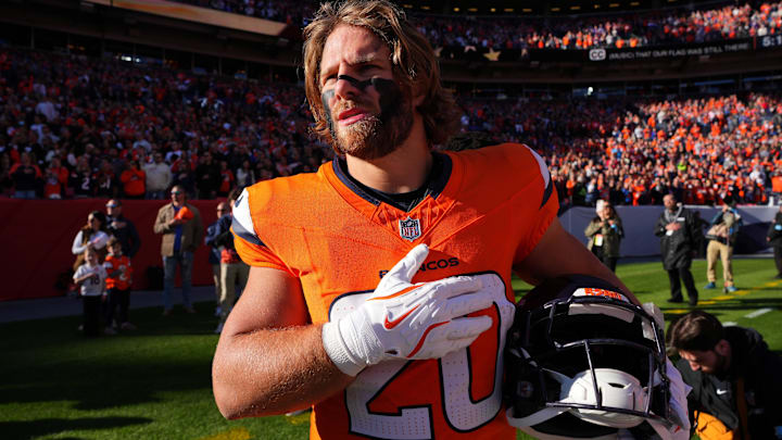 Nov 17, 2024; Denver, Colorado, USA; Denver Broncos fullback Michael Burton (20) during the American national anthem before the game against the Atlanta Falcons at Empower Field at Mile High. Mandatory Credit: Ron Chenoy-Imagn Images