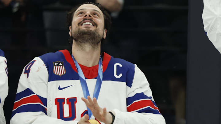 Feb 22, 2026; Milan, Italy; Auston Matthews (34) of the United States and Connor Hellebuyck (37) of the United States celebrate their gold medals against Canada in the men's ice hockey gold medal game during the Milano Cortina 2026 Olympic Winter Games at Milano Santagiulia Ice Hockey Arena. Mandatory Credit: Geoff Burke-Imagn Images Feb 22, 2026; Milan, Italy; Auston Matthews (34) of the United States and Connor Hellebuyck (37) of the United States celebrate their gold medals against Canada in the men's ice hockey gold medal game during the Milano Cortina 2026 Olympic Winter Games at Milano Santagiulia Ice Hockey Arena. Mandatory Credit: Geoff Burke-Imagn Images