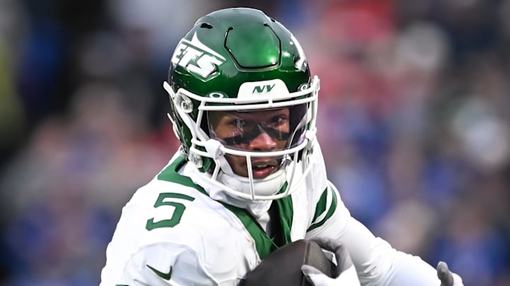 Dec 29, 2024; Orchard Park, New York, USA; New York Jets wide receiver Garrett Wilson (5) runs with the ball after making a catch against the Buffalo Bills in the first quarter at Highmark Stadium. Mandatory Credit: Mark Konezny-Imagn Images