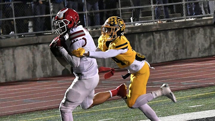 Landen Miree tucks in a touchdown catch for Princeton in the OHSAA Division I football regional semifinals Nov. 15, 2024, at Dwire Field Mason, Ohio.