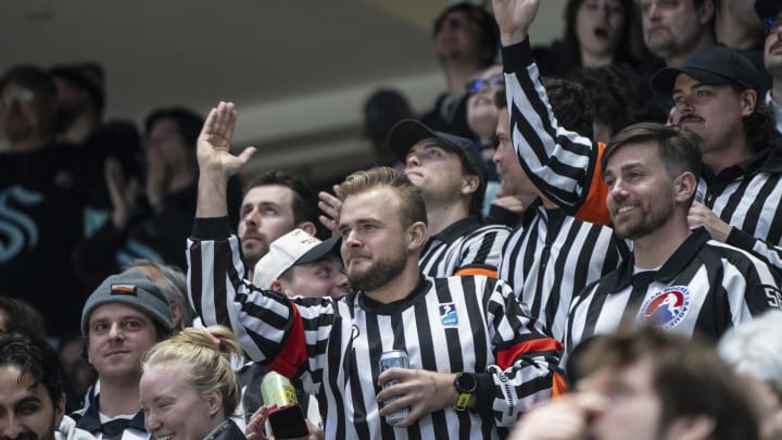 Apr 11, 2024; Seattle, Washington, USA; Fans dressed as referees cheer during the first period between the San Jose Sharks and the Seattle Kraken at Climate Pledge Arena. Mandatory Credit: Stephen Brashear-USA TODAY Sports Apr 11, 2024; Seattle, Washington, USA; Fans dressed as referees cheer during the first period between the San Jose Sharks and the Seattle Kraken at Climate Pledge Arena. Mandatory Credit: Stephen Brashear-USA TODAY Sports