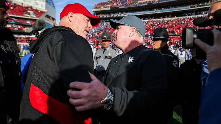Louisville head coach Jeff Brohm congratulates Kentucky head coach Mark Stoops