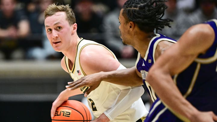 Purdue Boilermakers guard Fletcher Loyer (2) looks to get past Washington Huskies guard Quimari Peterson (0)