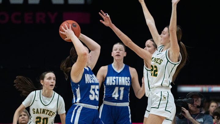 Newell-Fonda's Jocee Walsh looks to pass the ball against Council Bluffs St. Albert's Molly Wise (22) and Avah Underwood (40) during the 1A IGHSAU state basketball championship at Wells Fargo Arena on Saturday, March 8, 2025, in Des Moines.