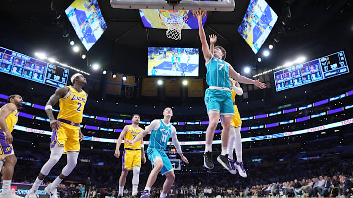 Jan 15, 2026; Los Angeles, California, USA; Charlotte Hornets guard Kon Knueppel (7) shoots the ball against Los Angeles Lakers forward Rui Hachimura (28) in the first half at Crypto.com Arena. Mandatory Credit: Kirby Lee-Imagn Images