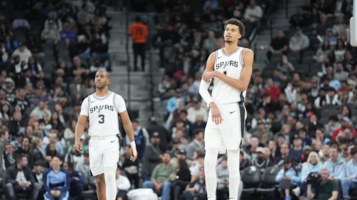 Jan 17, 2025; San Antonio, Texas, USA; San Antonio Spurs guard Chris Paul (3) and center Victor Wembanyama (1) look on in the second half against the Memphis Grizzlies at Frost Bank Center. Mandatory Credit: Daniel Dunn-Imagn Images